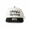 vibing and thriving Trucker Hat